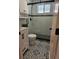 Modern bathroom featuring decorative black and white patterned tile floor and tiled shower with glass door at 2274 S Cherry St, Denver, CO 80222