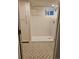 Bathroom boasts a walk-in shower with light tile, patterned tile floor, and white storage cabinet at 2274 S Cherry St, Denver, CO 80222