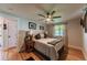 Comfortable bedroom features hardwood floors, a ceiling fan, and ample natural light at 2274 S Cherry St, Denver, CO 80222