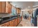 Charming kitchen features wooden cabinets, granite countertops, stainless appliances, and an adjacent dining area at 2274 S Cherry St, Denver, CO 80222