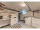 Basement laundry room with washer, dryer, utility sink, and storage at 2274 S Cherry St, Denver, CO 80222
