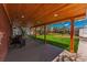 Covered outdoor patio area overlooking a spacious fenced backyard with a lush lawn at 2274 S Cherry St, Denver, CO 80222