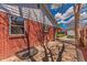Brick patio area with window well and white painted trim near backyard at 2274 S Cherry St, Denver, CO 80222