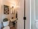 Compact powder room showcasing a wall-mounted sink, toilet, and decorative wall accents at 2274 S Cherry St, Denver, CO 80222