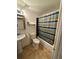 Cozy bathroom including a tub with striped curtain, a toilet, pedestal sink and mirror at 4740 W 108Th Pl, Westminster, CO 80031