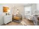 Charming Bedroom featuring a cozy crib, soft decor, ample natural light, and stylish furnishings at 3234 Belleville Ridge Rd, Elizabeth, CO 80107
