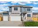 Two-story home showcasing a two-car garage, stone accents, and a manicured lawn beneath a bright sky at 3234 Belleville Ridge Rd, Elizabeth, CO 80107