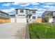 A well-maintained home with a two-car garage, green lawn, and stylish exterior design under blue sky at 3234 Belleville Ridge Rd, Elizabeth, CO 80107