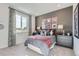 Stylish bedroom with a gray accent wall, plush bedding, and a large window for natural light and beautiful views at 14128 Bunny Hop Ln, Parker, CO 80134