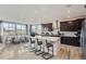 Modern kitchen with stainless steel appliances, a large island, and seamless flow into the dining area at 14128 Bunny Hop Ln, Parker, CO 80134