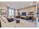 Comfortable living room with stylish accent wall, two desks, modern furniture, and plenty of natural light at 14128 Bunny Hop Ln, Parker, CO 80134