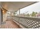 Private balcony with a wood deck and lattice railing, offering outdoor space at 8335 Fairmount Dr # 7-207, Denver, CO 80247