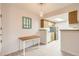 Eat in kitchen featuring light wood cabinetry and standard appliances at 8335 Fairmount Dr # 7-207, Denver, CO 80247