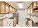 Functional kitchen featuring light wood cabinetry and standard appliances at 8335 Fairmount Dr # 7-207, Denver, CO 80247