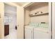 Convenient laundry area with a stacked washer and dryer, located within the unit at 8335 Fairmount Dr # 7-207, Denver, CO 80247