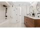 Modern bathroom featuring double vanity, sleek fixtures, and a tiled shower-tub combination at 2641 N Clayton St, Denver, CO 80205