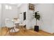Bright dining area with white table, chairs, hardwood floors and built-in storage at 2641 N Clayton St, Denver, CO 80205