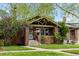 Charming brick bungalow featuring well-maintained lawn and beautiful landscaping at 2641 N Clayton St, Denver, CO 80205