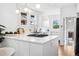 Modern kitchen featuring white countertops, ample cabinet space, and updated appliances at 2641 N Clayton St, Denver, CO 80205