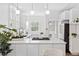 Bright kitchen features a center island, stainless appliances, and pendant lighting at 2641 N Clayton St, Denver, CO 80205