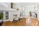 Bright living room featuring a fireplace, built-in shelving, and hardwood floors at 2641 N Clayton St, Denver, CO 80205