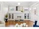 Cozy living room with a decorative fireplace, built-in shelving, and large windows at 2641 N Clayton St, Denver, CO 80205