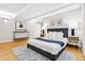 Well-lit main bedroom featuring hardwood floors, soft decor, and modern furnishings at 2641 N Clayton St, Denver, CO 80205