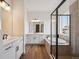 Bathroom featuring dual vanities, soaking tub, and walk-in shower with modern finishes at 1111 Joseph Pl, Erie, CO 80026
