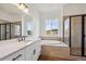 Bright bathroom with dual sinks, large soaking tub, and glass-enclosed shower at 1111 Joseph Pl, Erie, CO 80026
