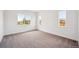 Bright bedroom with three large windows and neutral-toned carpeting at 1111 Joseph Pl, Erie, CO 80026