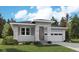 Modern one-story home with stone and siding accents, two-car garage, and landscaped yard at 1111 Joseph Pl, Erie, CO 80026