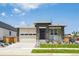 Charming home with stone accents, a well-maintained lawn, and attached two-car garage at 1111 Joseph Pl, Erie, CO 80026