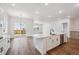 Bright kitchen and dining area with white cabinets, stainless appliances, quartz counters, and sliding glass doors to backyard at 1111 Joseph Pl, Erie, CO 80026