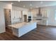 Open concept kitchen features a large center island, stainless steel appliances, and white cabinetry at 1111 Joseph Pl, Erie, CO 80026