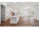 Open concept kitchen featuring a large island, stainless steel appliances, and wood floors at 1111 Joseph Pl, Erie, CO 80026