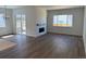 Bright living room featuring hardwood floors, fireplace, and sliding glass door to the backyard at 1111 Joseph Pl, Erie, CO 80026