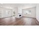 Spacious living room featuring a modern fireplace, large windows, and sliding glass doors with wood-look flooring at 1111 Joseph Pl, Erie, CO 80026