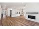 Open floor plan with fireplace and chef's kitchen with white cabinets, island, and stainless appliances at 1111 Joseph Pl, Erie, CO 80026