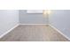 Bright bedroom featuring wood-look floors and neutral walls at 7455 E Quincy Ave # 101, Denver, CO 80237
