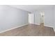 Spacious bedroom with light gray walls and wood-look floors at 7455 E Quincy Ave # 101, Denver, CO 80237