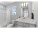 Well-lit bathroom featuring a large mirror, modern vanity, and a shower-tub combination with white tile at 22043 E 38Th Pl, Aurora, CO 80019