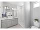 Bright bathroom featuring double sinks, a subway-tiled shower, and contemporary fixtures at 22043 E 38Th Pl, Aurora, CO 80019