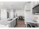 Bright kitchen featuring stainless steel appliances, gray cabinets, and a dining area at 22043 E 38Th Pl, Aurora, CO 80019