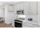 Modern kitchen boasts white cabinets, subway tile backsplash, and stainless steel oven at 22043 E 38Th Pl, Aurora, CO 80019
