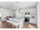 Open kitchen with a quartz island, pendant lighting, stainless appliances, and bar stool seating at 22043 E 38Th Pl, Aurora, CO 80019