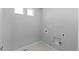 A new, empty laundry room with tile floor and washer-dryer hookups ready for appliances at 22043 E 38Th Pl, Aurora, CO 80019