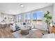 Open-concept: living area with large windows, bright kitchen, and bar stool seating at 22043 E 38Th Pl, Aurora, CO 80019