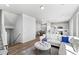 Bright and airy living room featuring a modern design with hardwood floors that seamlessly flows into the kitchen and dining areas at 22043 E 38Th Pl, Aurora, CO 80019