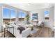 Bright living room with large windows, modern decor, and cozy seating arrangement at 22043 E 38Th Pl, Aurora, CO 80019