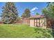 Well maintained backyard, storage shed, lawn, trees and wood fence at 9270 Tennyson St, Westminster, CO 80031